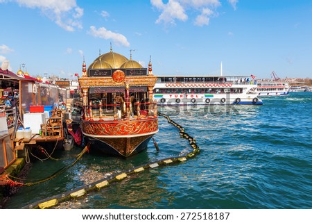 ISTANBUL, TURKEY - APRIL10,2015: fish restaurant boats at the banks of the Eminoenue district of Istanbul with unidentified people. Istanbul is the largest city in Turkey and famous travel destination