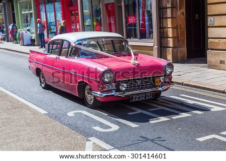 BATH, ENGLAND - JULY04,2015: old Vauxhall with unidentified people. Vauxhall is a British automotive company headquartered in England, affiliated company of German Opel AG and owned subsidiaries of GM