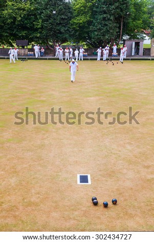 BATH, ENGLAND - JULY 04, 2015: unidentified bowls player on a green in Bath. Bowls is a sport going back to 13th century. At present it becomes played in GB, US, Australia, Canada, and a view others