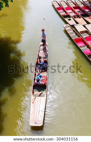 OXFORD, ENGLAND - JULY 03, 2015: boats on the river Avon with unidentified people. Oxford is known worldwide as home of the University of Oxford, the oldest university in the English-speaking world