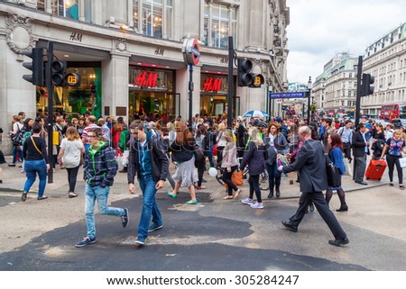 LONDON, ENGLAND - MAY 20, 2014: Oxford Circus with unidentified people in London. Up to over 40.000 pedestrians per hour pass the junction, it is the highest pedestrian volumes recorded in London.
