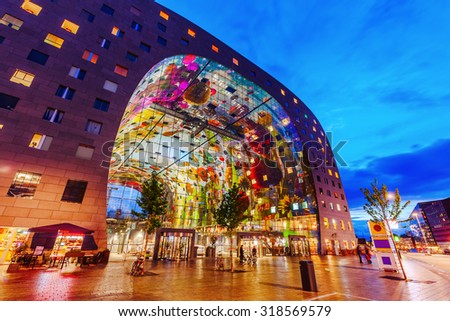 ROTTERDAM, NETHERLANDS - SEPTEMBER 03, 2015: modern market hall in Rotterdam at night. It was opened Oct 1, 2014 by Queen Maxima, designed by architect firm MVRDV. With unidentified people