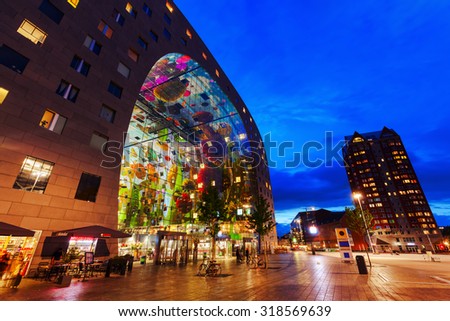 ROTTERDAM, NETHERLANDS - SEPTEMBER 03, 2015: modern market hall in Rotterdam at dawn. It was opened Oct 1, 2014 by Queen Maxima, designed by architect firm MVRDV. With unidentified people