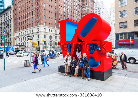 NEW YORK CITY - OCTOBER 07, 2015: Love sculpture in Midtown Manhattan with unidentified people. It is from artist Robert Indiana, a pop art artist, His media include paper and Cor-ten steel sculpture.