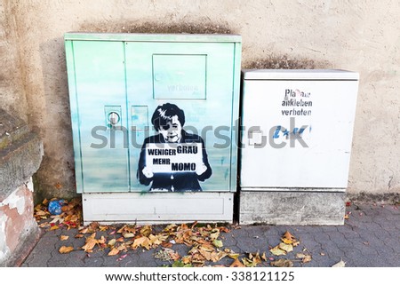 TRIER, GERMANY - NOVEMBER 05, 2015: political stencil graffiti at a breaker box in Trier. Stencil graffiti is a form that makes use of stencils made of paper or other media to create an image or text