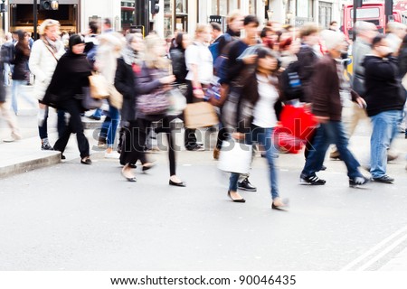 shopping people crossing a street in London
