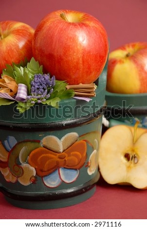 Apples in wooden buckets painted in Norwegian Rosemaling style.