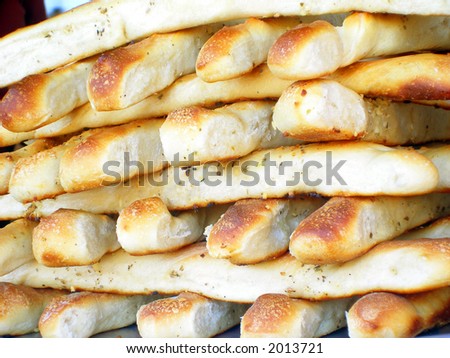Stacks of bread sticks at pizza vendor at an outdoor event.