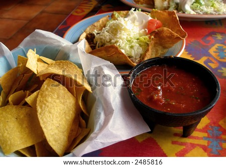 stock photo : Tortilla chips, salsa, and taco salad at a Mexican restaurant.