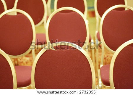 Chairs lined up in a conference room at a convention center, waiting for the the next meeting.