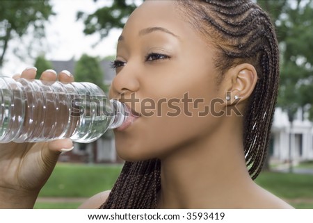 Young Woman Drinking from a Bottle of Water