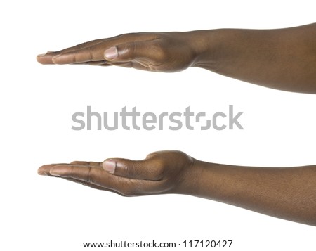 Close-up image of a human hand holding something against the white surface