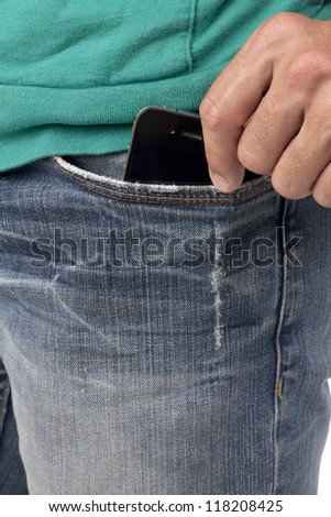 Close-up image of human hand holding phone inside the pocket