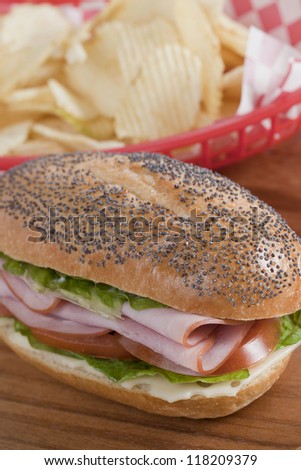 High angle shot of yummy ham sandwich and chips