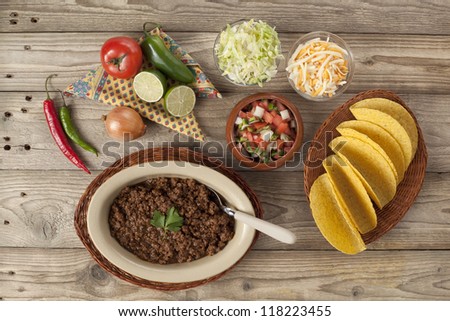 Ground beef tacos, preparation ingredients set in a wooden table
