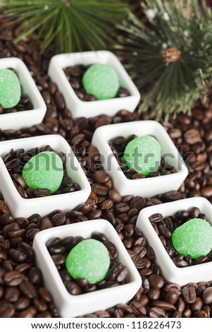 Green jelly candies with coffee beans on a dish