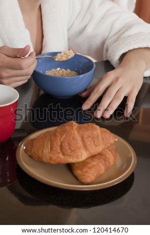 Close up image of unrecognized person eating breakfast