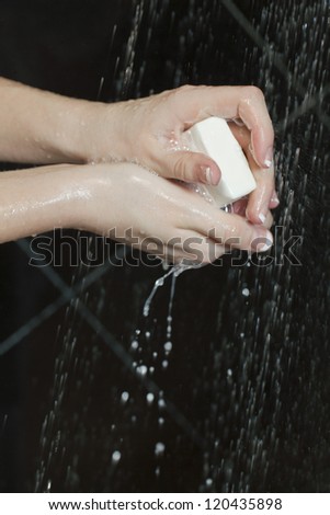 Cleaning hands using bar of soap and water