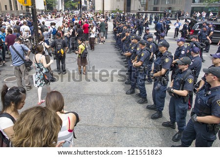 TORONTO, ON/CANADA - JUNE 27, 2010:  G20 Protesters gather in from of riot police on June 27, 2010 in Toronto