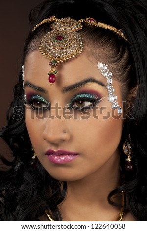 Close-up shot of a young attractive female with make-up and elegant jewelry