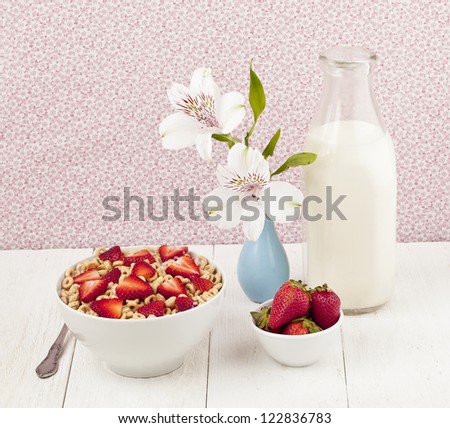 Cereal rings with strawberries and milk bottle