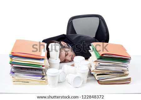 Tired young businessman asleep at work