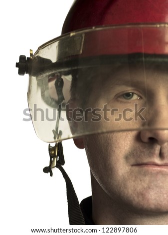 Close-up image of a fireman's half face against the white surface