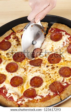 Cutting Pepperoni Pizza with Pizza Cutter