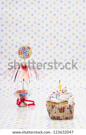 Cupcake with a candle and birthday sign