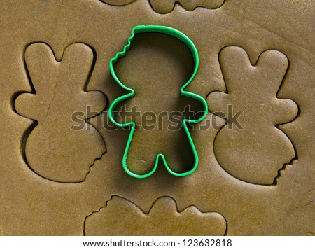 Green cookie cutter in the top of dough