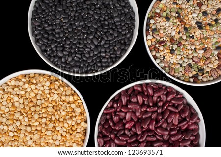 Overhead shot of variety of food grains in plastic bowls.