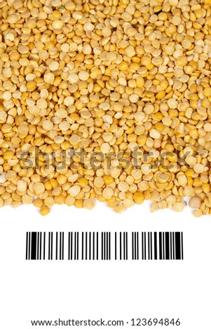 Close-up shot of yellow lentils and barcode on white background.