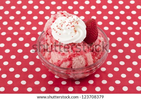Close up strawberry ice cream in crystal bowl against white background