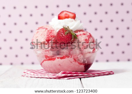 Close-up image of melted strawberry ice cream with strawberry fruit toppings