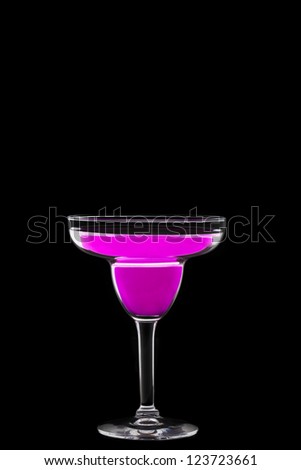 Close-up shot of pink cocktail drink in martini glass against plain black background.