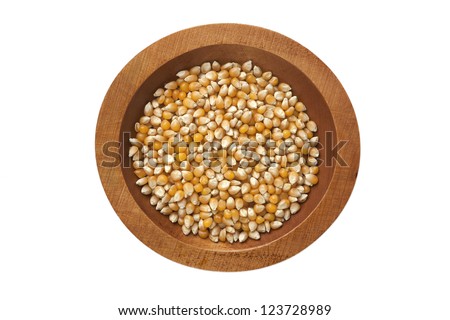 A top view image of a maize on a wooden bowl isolated on