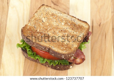 Close up image of delicious bacon sandwich on wooden  table