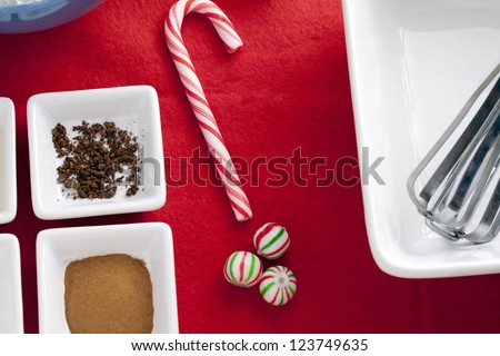 A portrait of a baking ingredient and candies with a white bowl and whisk on the side