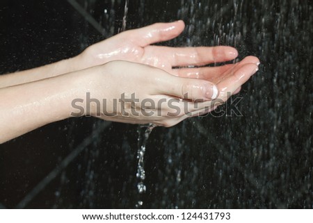 Close up image of woman washing her hands on the running water