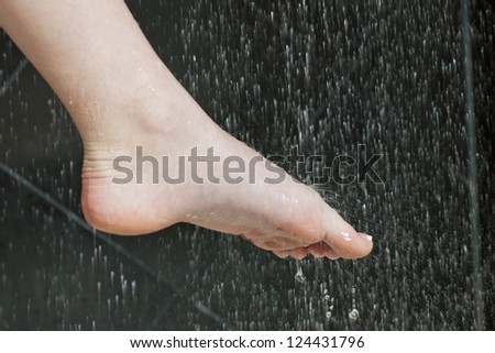 Close-up image of a female foot washing on shower