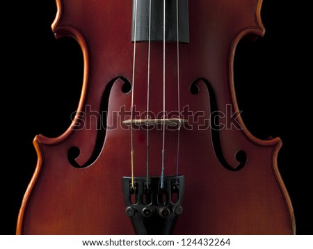 Old violin with bridge on waist bout, isolated on black background