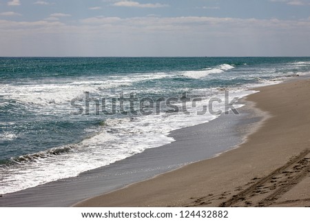 Waves roll up and down the beach in Palm Beach, Florida.