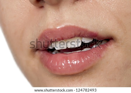 Close-up image of a woman\'s shiny lips isolated on a white surface