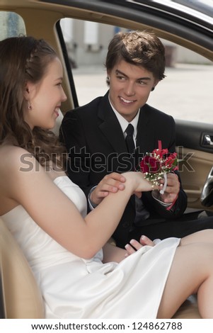 Closed up shot of a romantic teenage couple inside the car