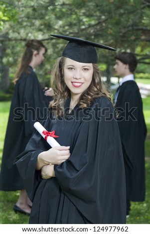 Close-up image of happy girl with graduation gown on her graduation day