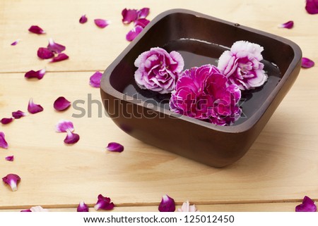 Close-up shot of pink flower in bowl of water.