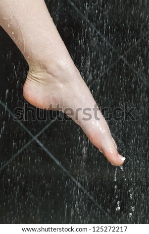 Close up image of woman washing her feet
