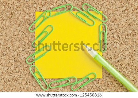 Image of adhesive paper with paper clips and ball pen