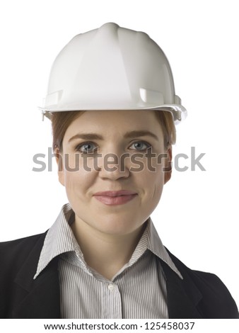 Closed up portrait of a smiling woman engineer wearing her helmet