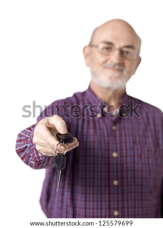 Portrait of old man giving a Car key with remote control in a front view image